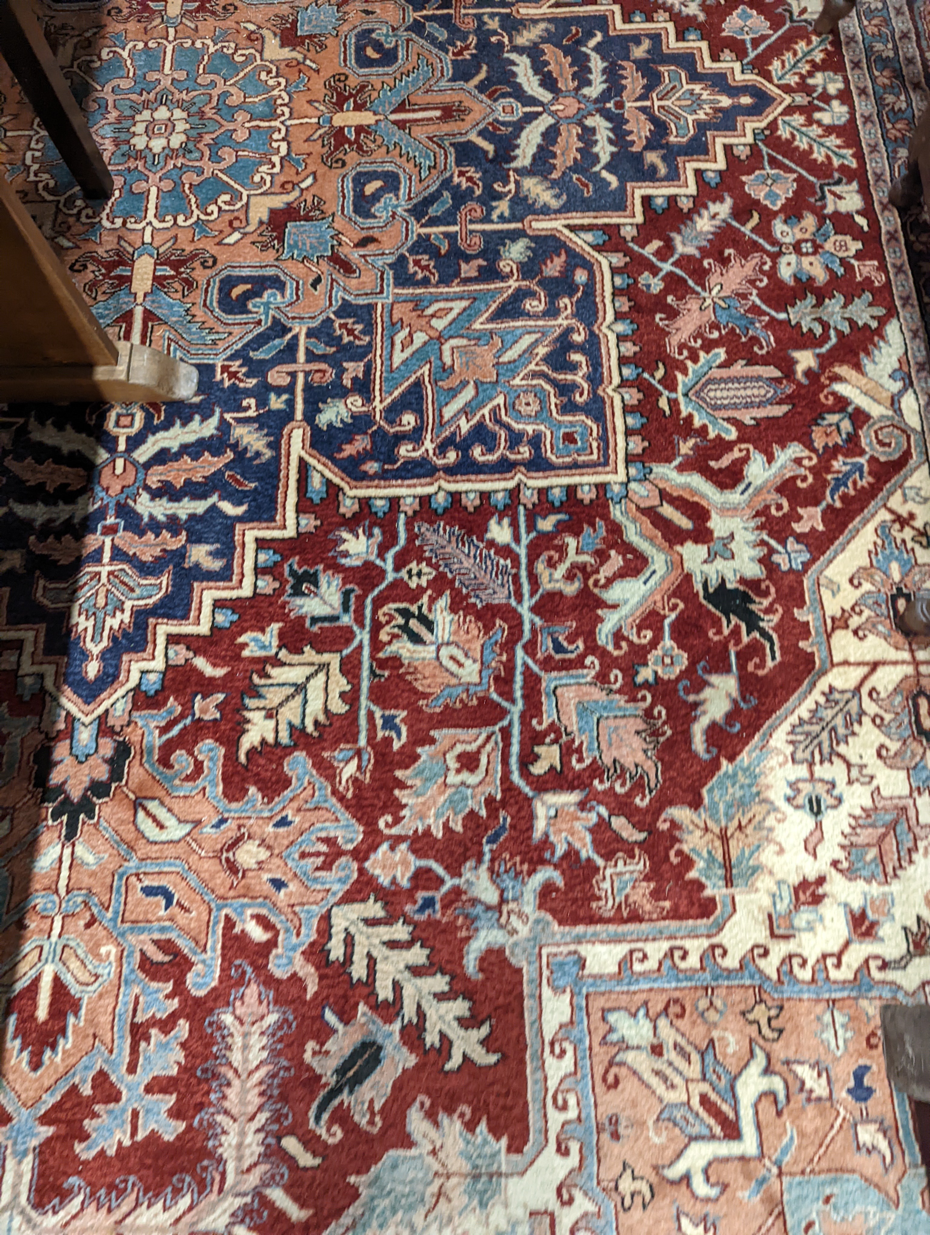 A large Caucasian style red ground carpet, 460 x 330cm